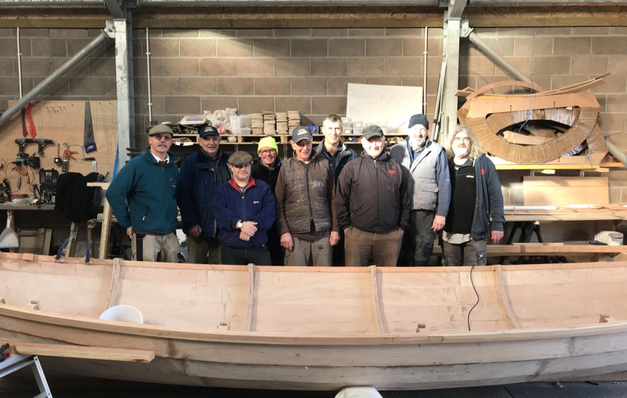 The group of volunteers who built the skiff Lady Bay
