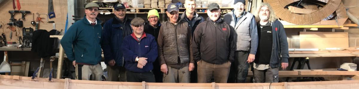 The group of volunteers who built the skiff Lady Bay