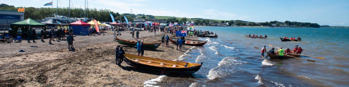 Skiffs lined up on the beach at Skiffie Worlds