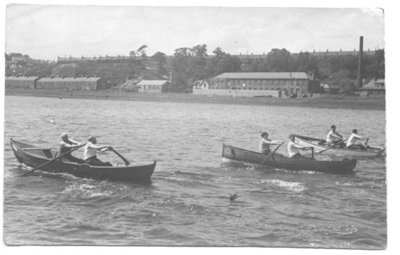 historic black and white image of skiff racing