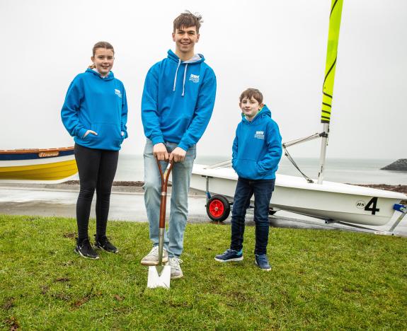 Young people break the sod at the construction site